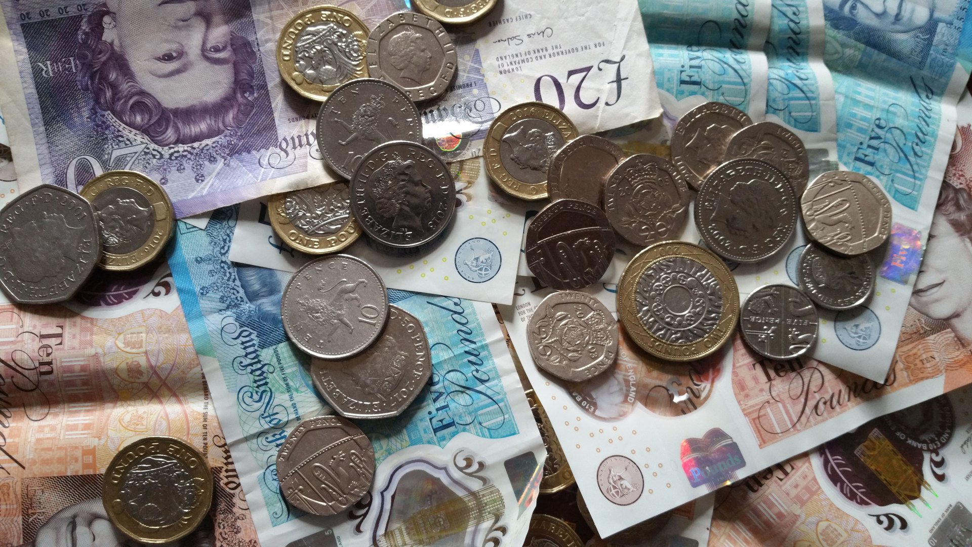 British pound notes and coins representing money and banking in the UK